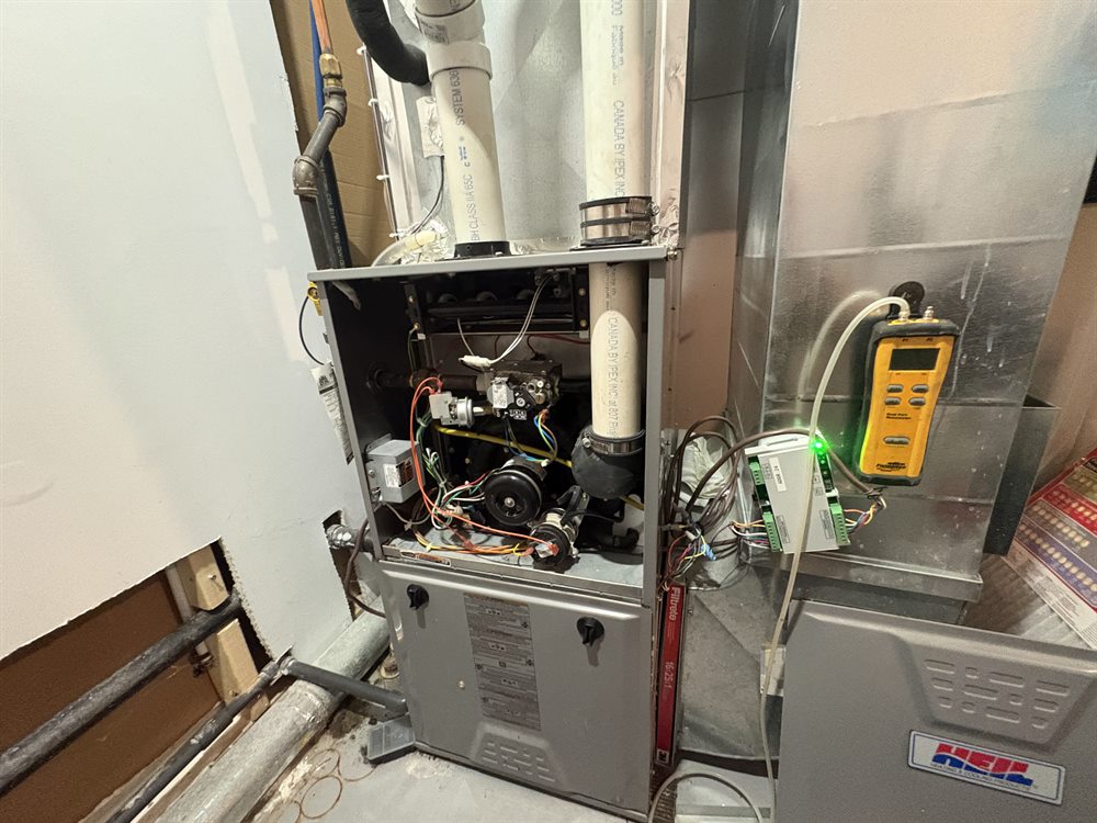 Open furnace cabinet with wiring and diagnostic equipment during service
