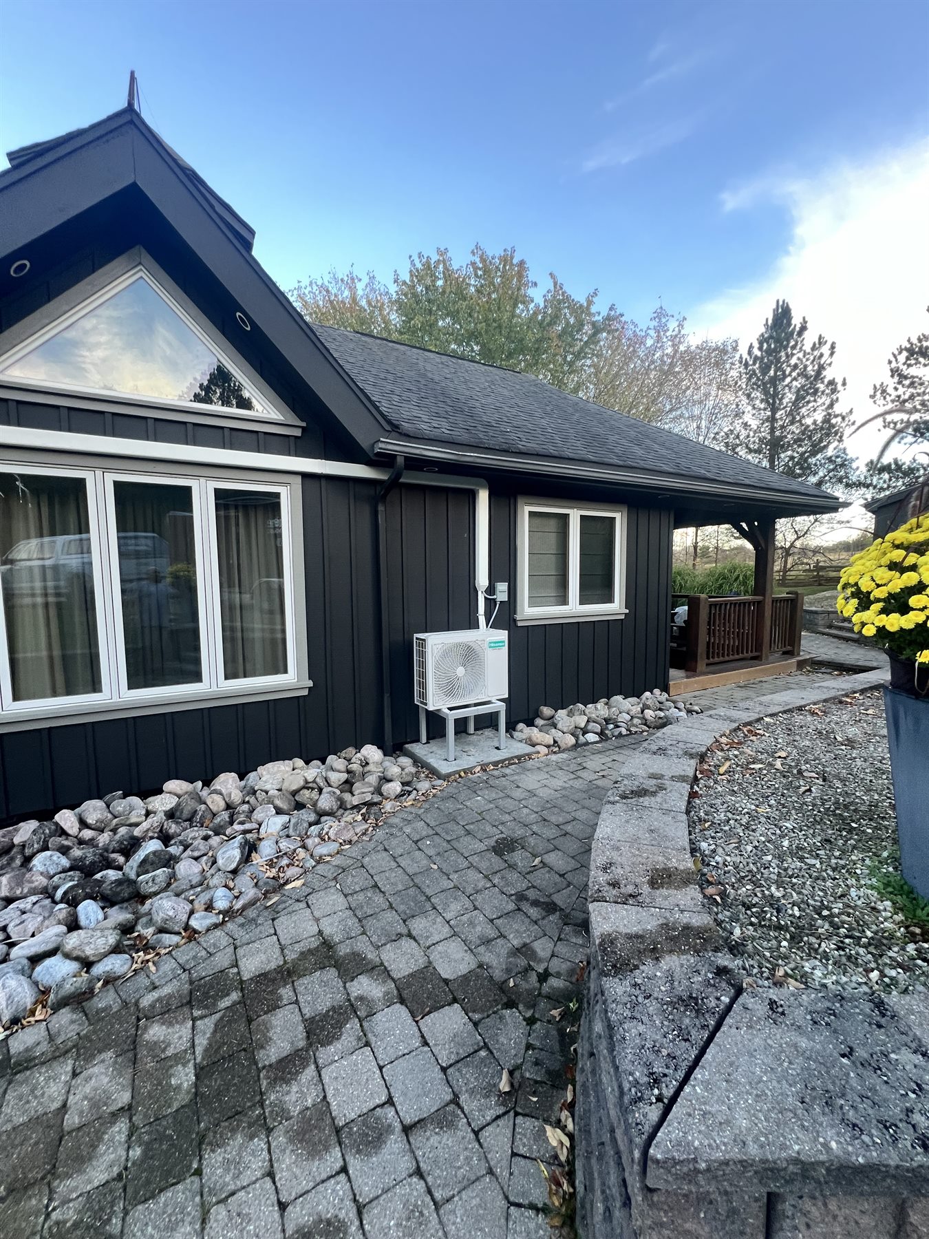 Outdoor heat pump installation on a finished home exterior