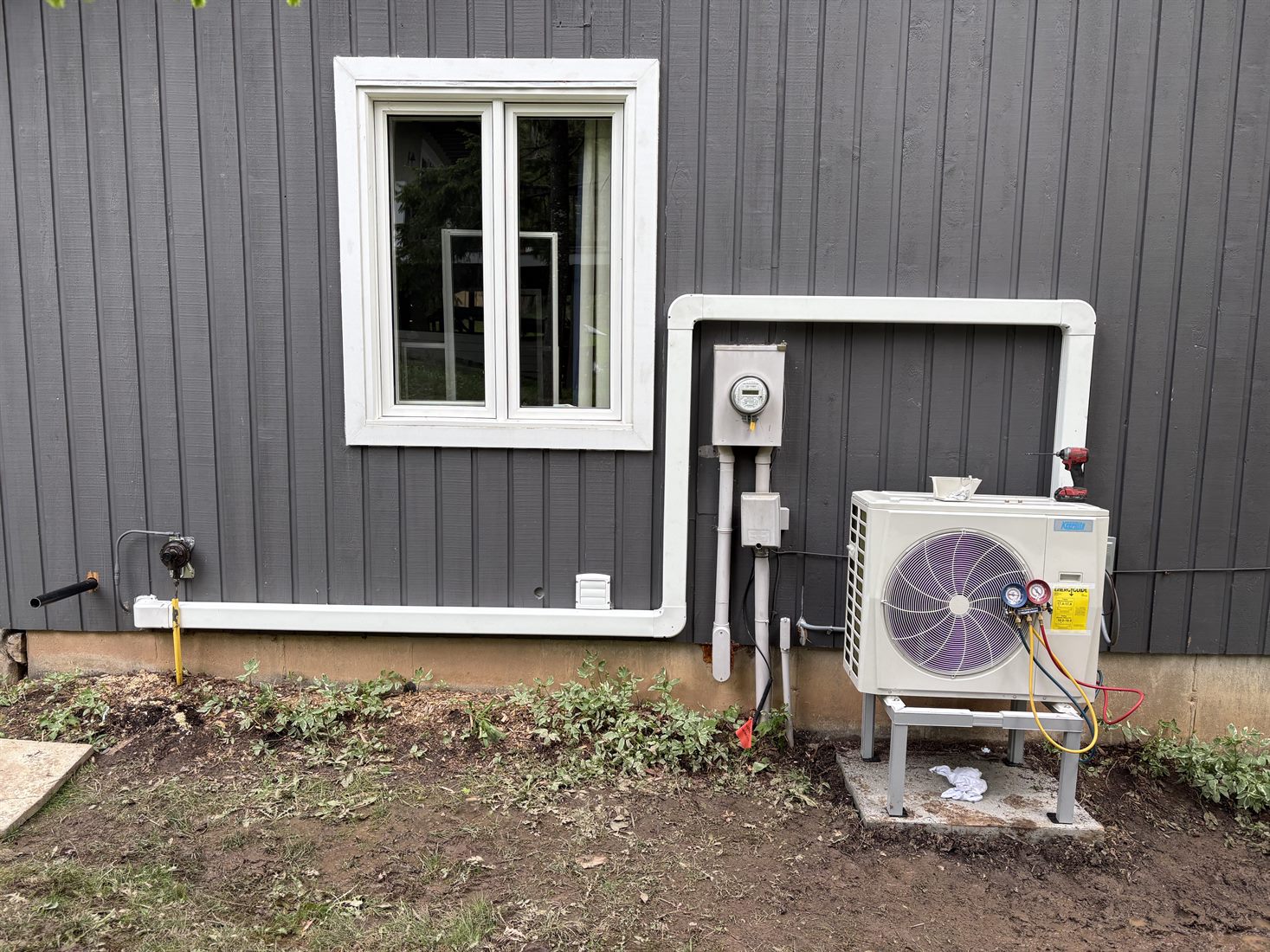 Outdoor heat pump installed beside a home